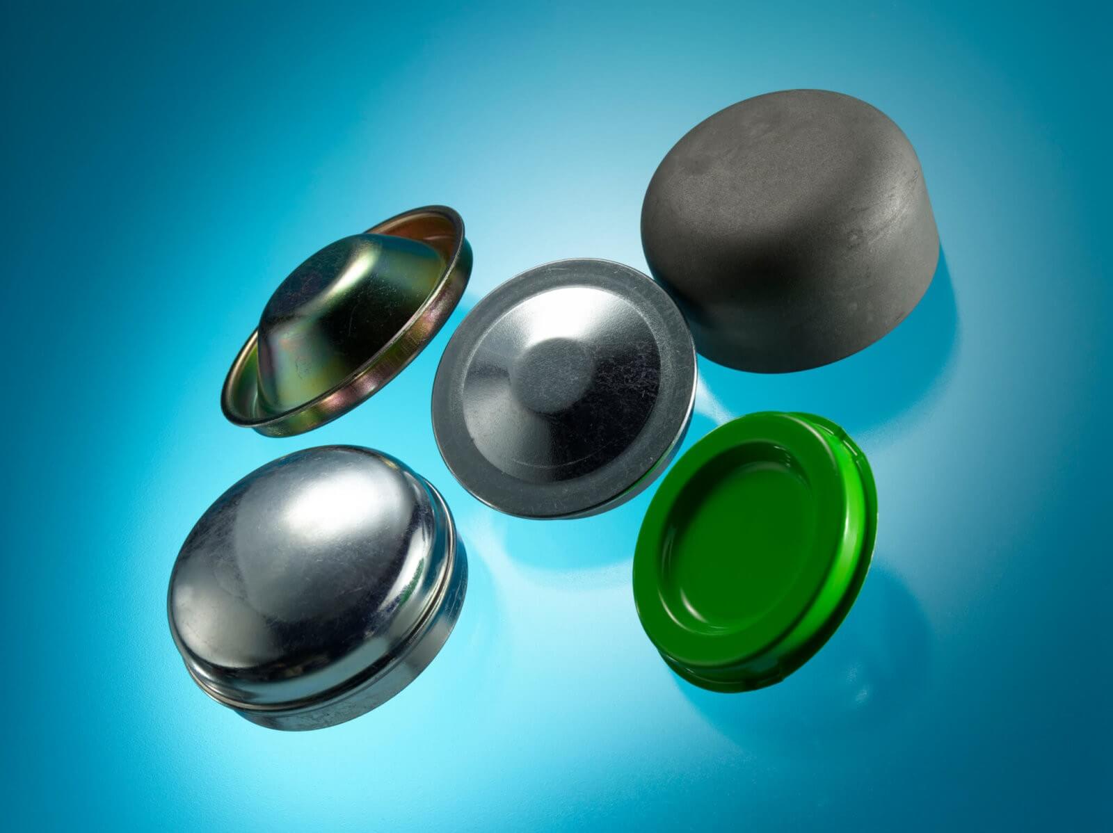 Automotive Parts Caps. Different cap and covers with black powder coating, Zinc and Clear Passivate or Zinc and Colour Passivate surface finishes.